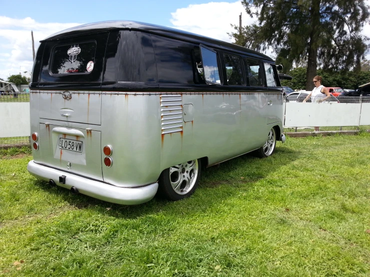 an old camper trailer parked on the grass