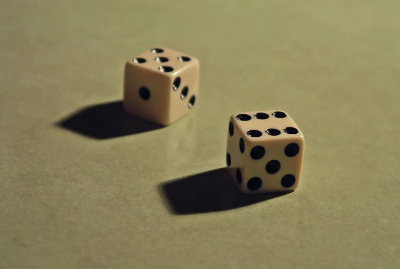 two dices in front of a green surface