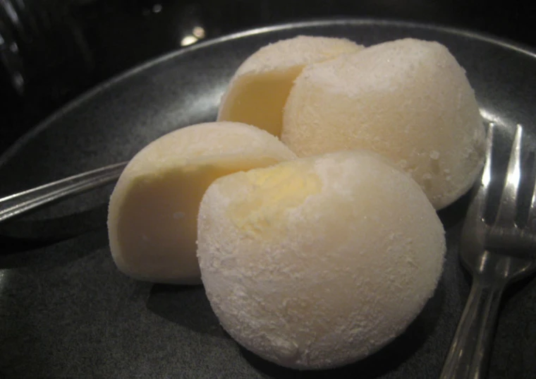 three ice cream balls on top of a plate