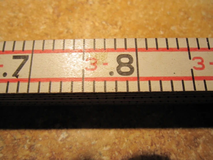 a ruler with the letter b is on a table