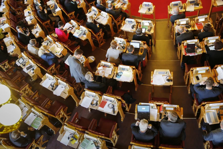 rows of tables with several people sitting at them