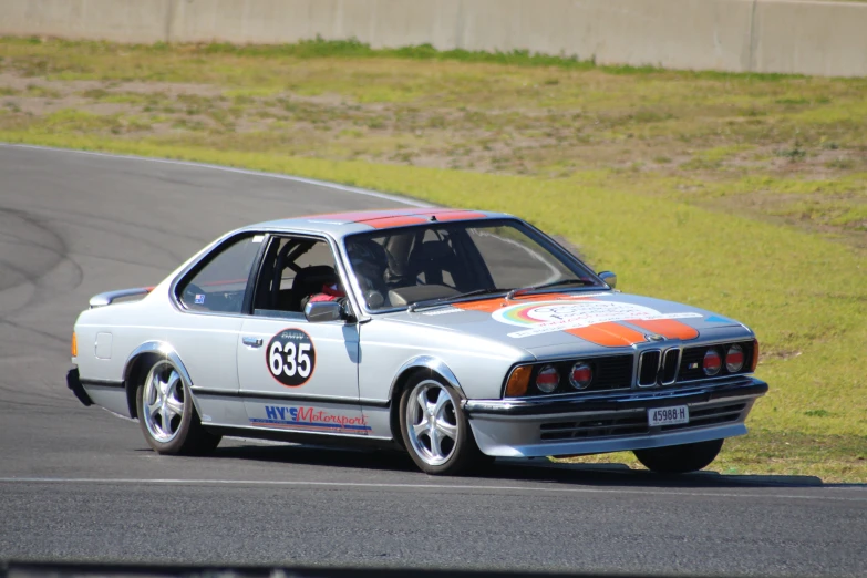 the classic race car is driving on the track