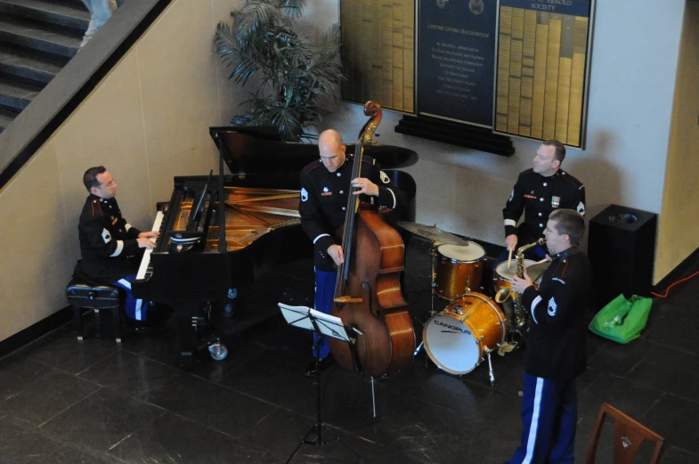 three band members in uniforms playing instruments together