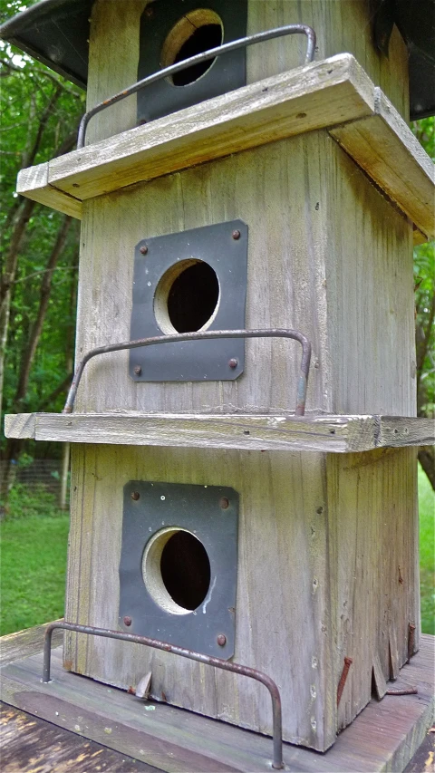 an odd old birdhouse is on the ground