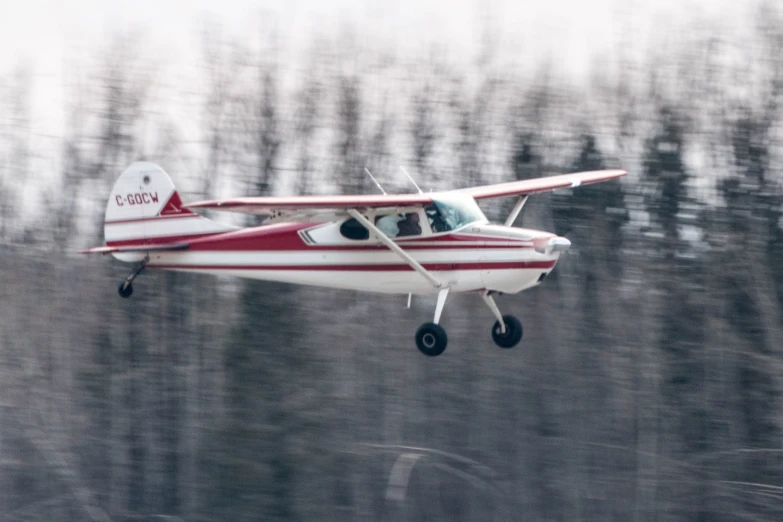 a small plane with a propeller is flying in the sky