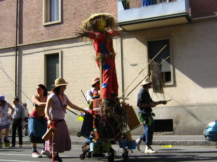 several people gathered around a large wooden sculpture