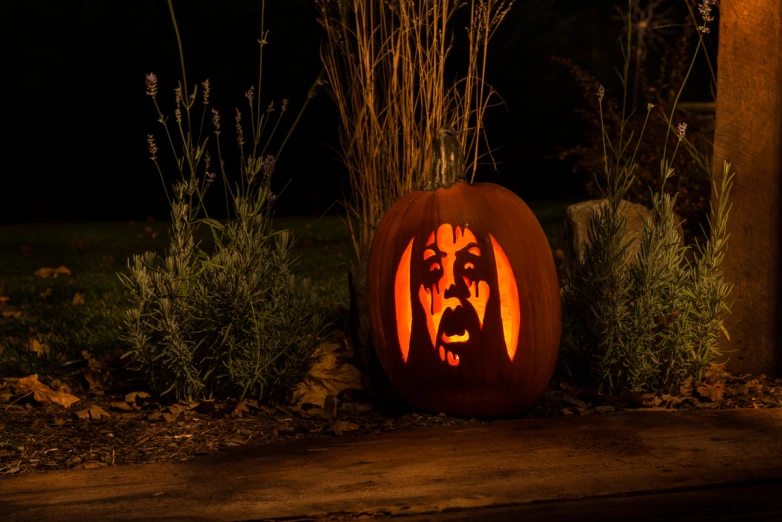 a carved pumpkin with a face and a head on it