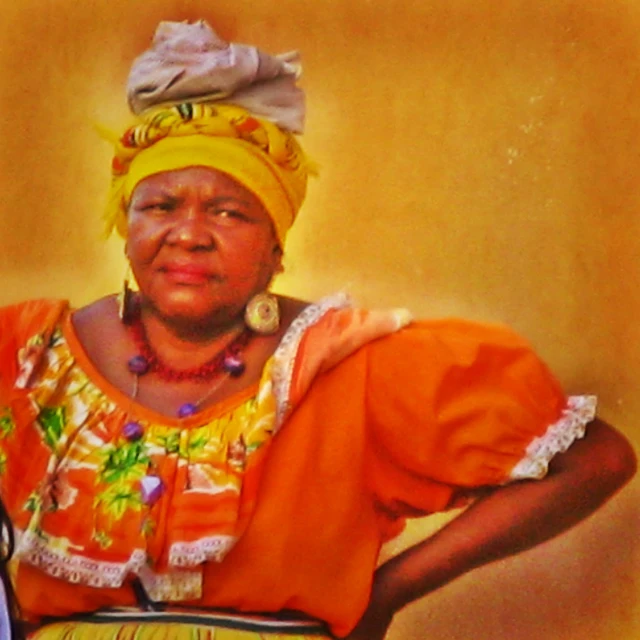 the woman is wearing orange and yellow attire