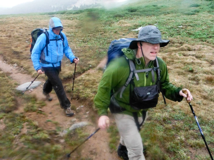 the two people are hiking up a hill