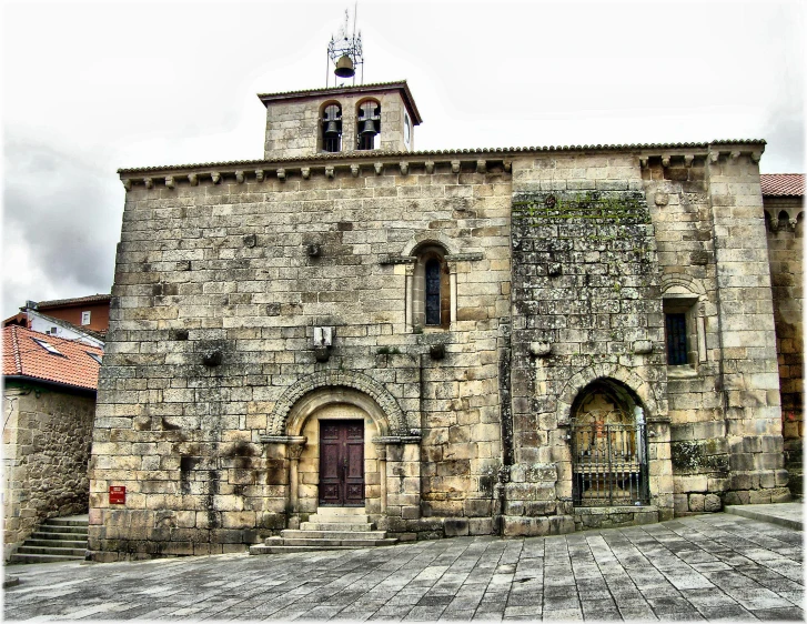 an old church is on a cloudy day