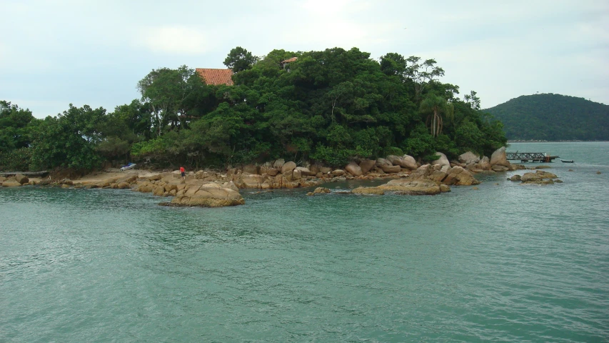 a group of rocks on a island in the middle of the ocean