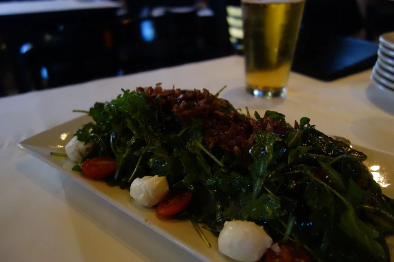 a plate with various vegetables and cheese on it