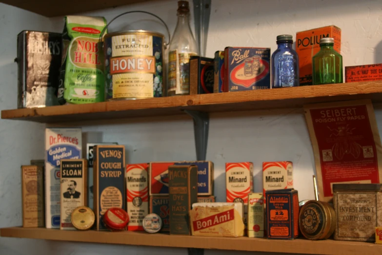 old antique tea cans are on the shelves