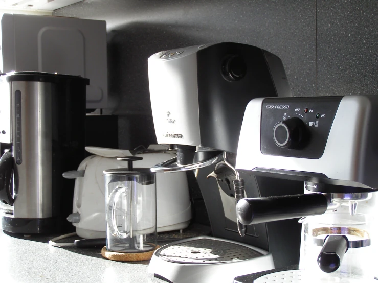 various coffee machines lined up on a counter