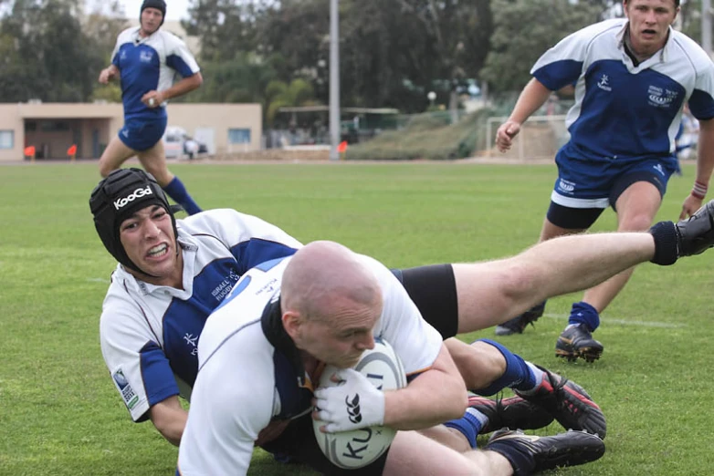 a group of young men playing a game of rugby