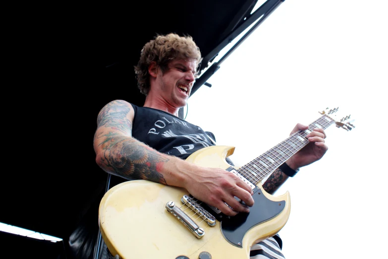 a man holding an electric guitar at a concert