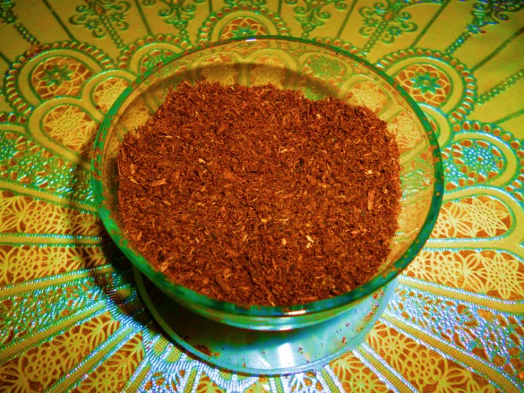 a small bowl is filled with red cocoa