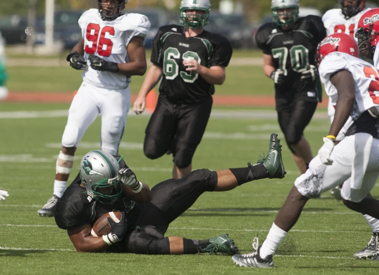 some players are on the field and one has his foot in the air