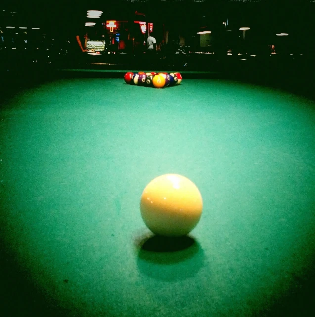 the ball is setting on the table in the game room