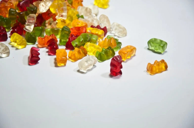 a close up of many gummy bears on a table