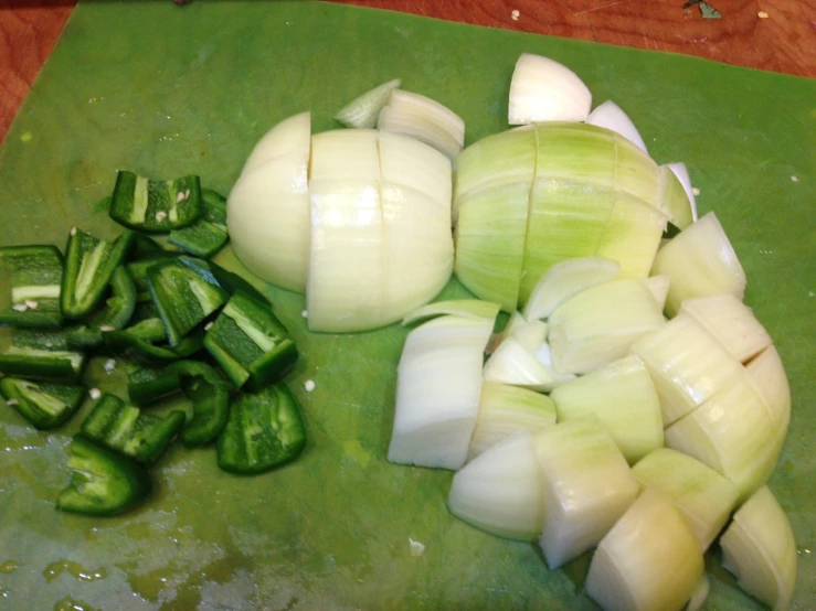 there are onion and peppers on a  board