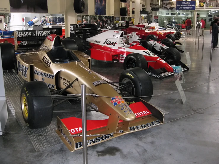 there are many cars on display at the car museum