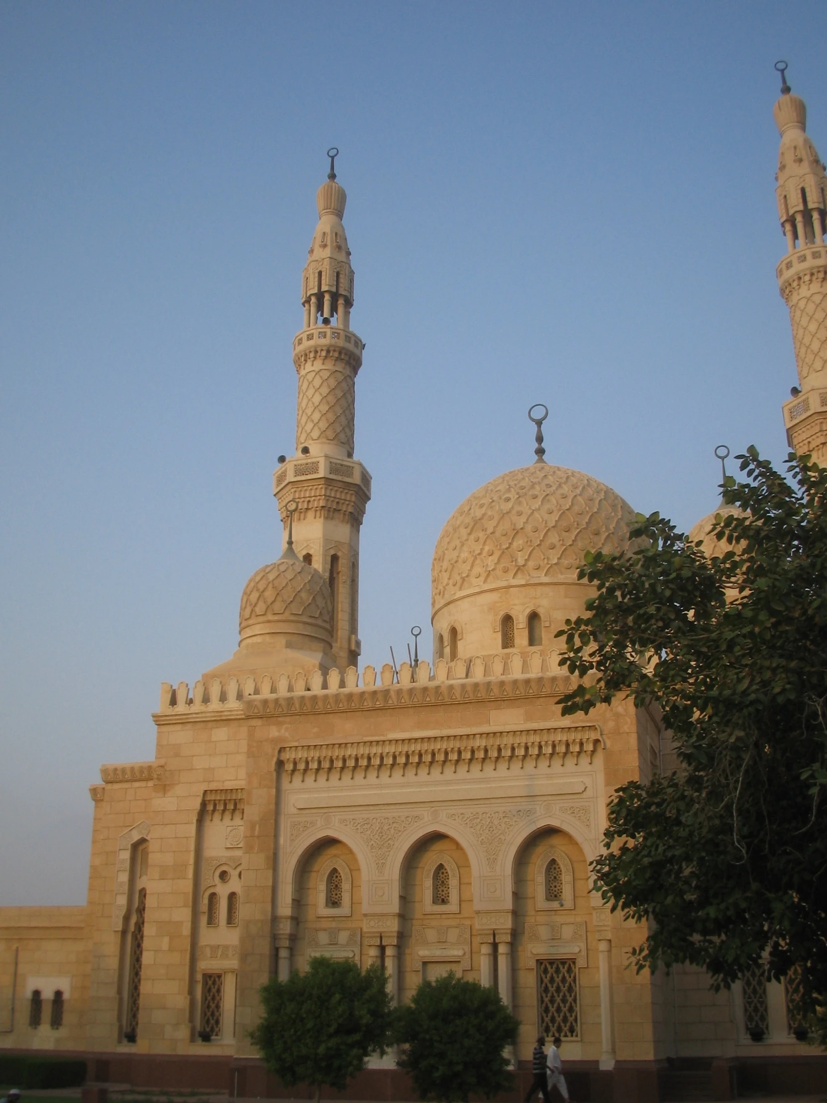 a tan building with two towers on the top