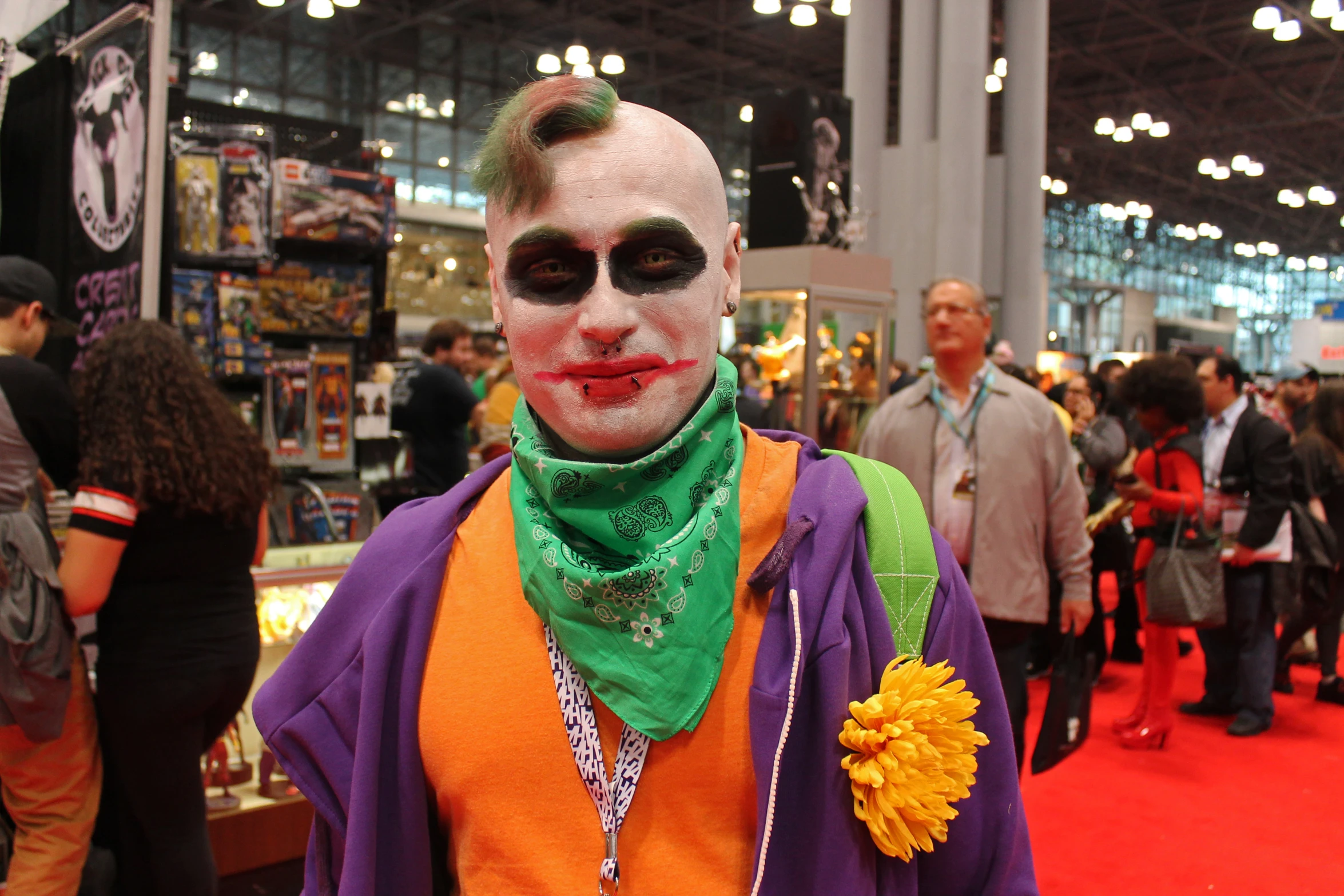 a man in a costume with a green tie and purple shirt