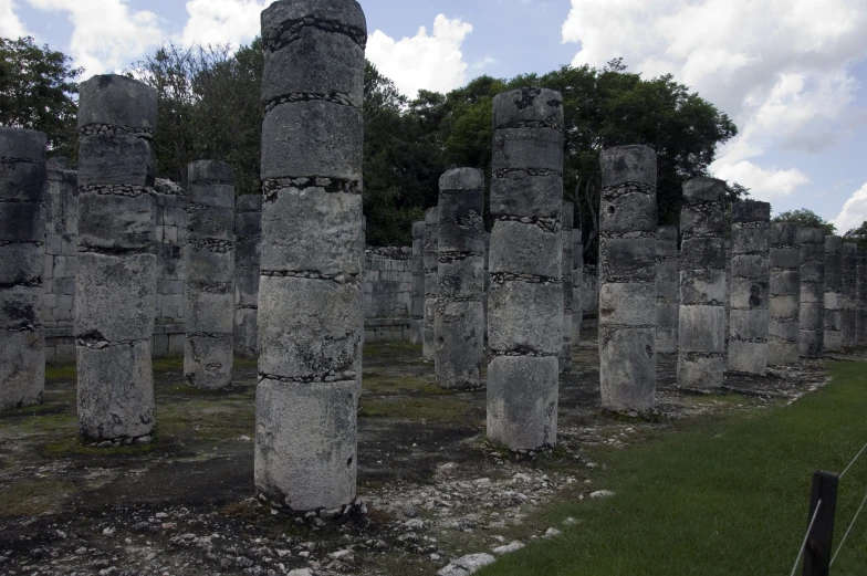 ancient stones sitting on grass near a building