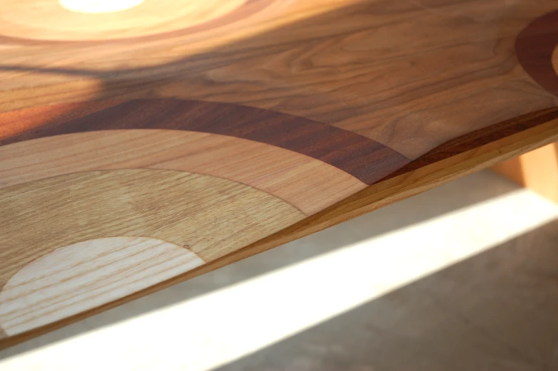 an odd shaped wooden table with a circular painted on it