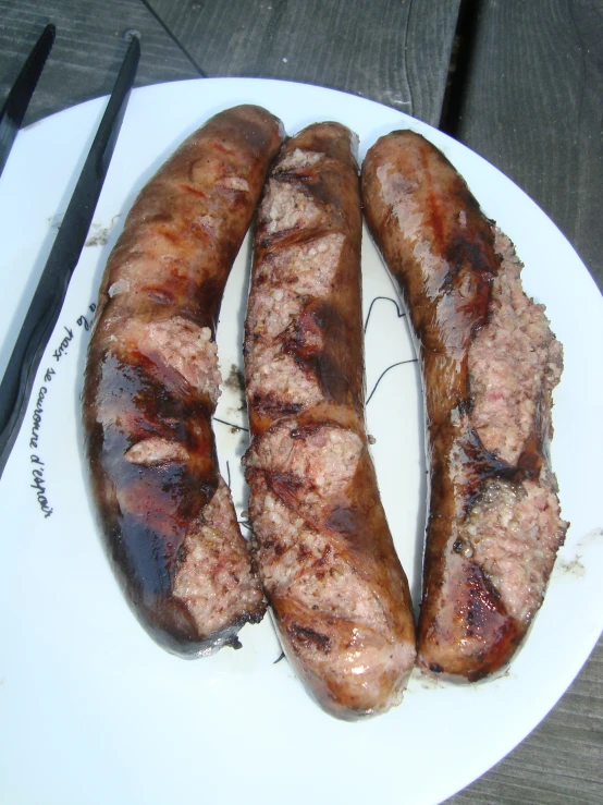 a plate with three sausages sitting on top of each other