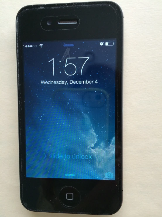 a black smart phone displaying the clock on its screen