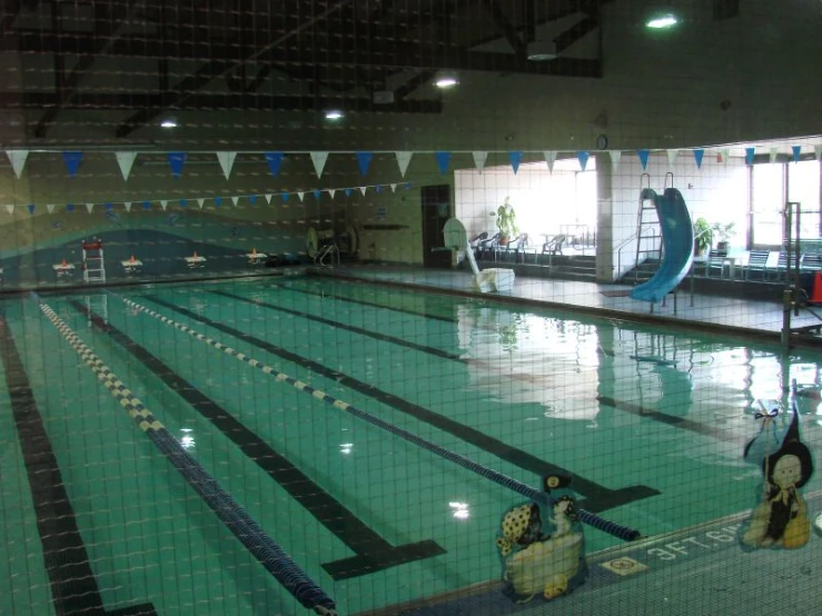 a pool with blue and white water and black and white flags