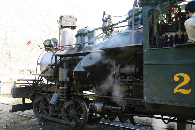 the engine of the train is steam billowing out the smoke