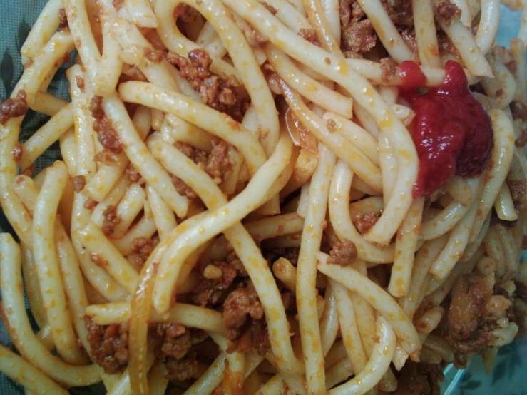 a close up of a plate with spaghetti and meat