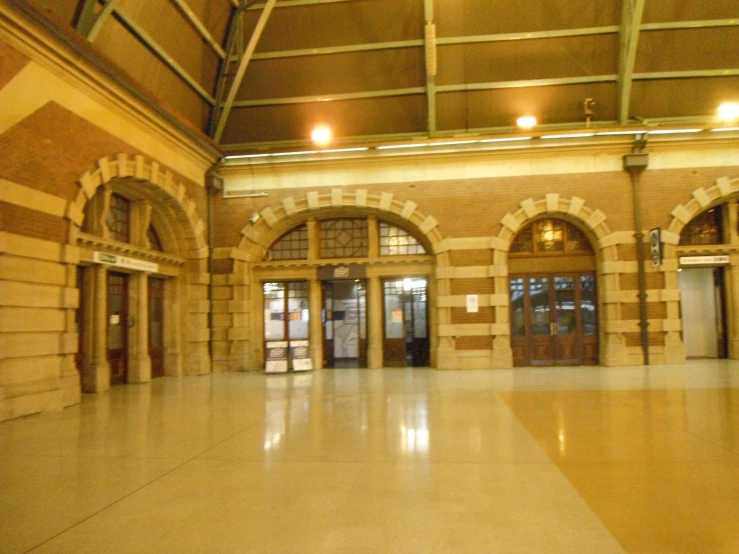 a large hall with several doors and a floor