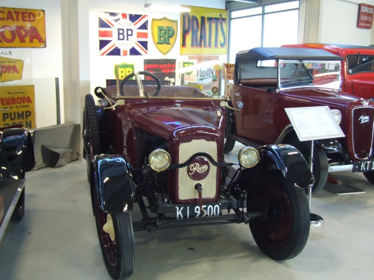 an antique car sits parked in a garage