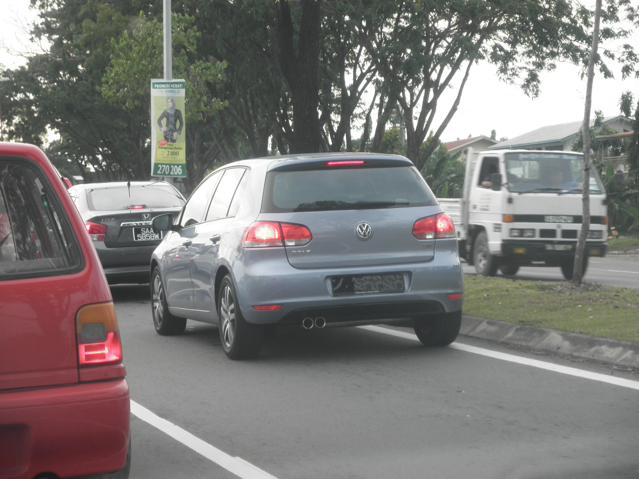 several cars drive on the same road