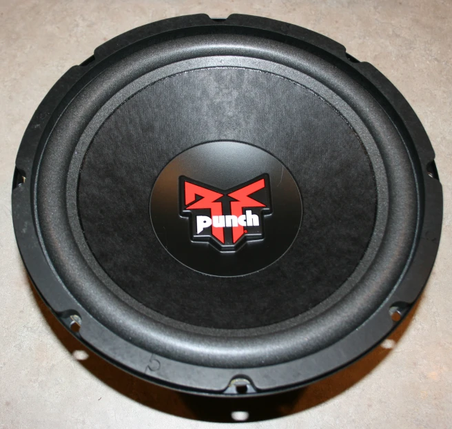 the back of a sub speaker with red and black emblem on the front