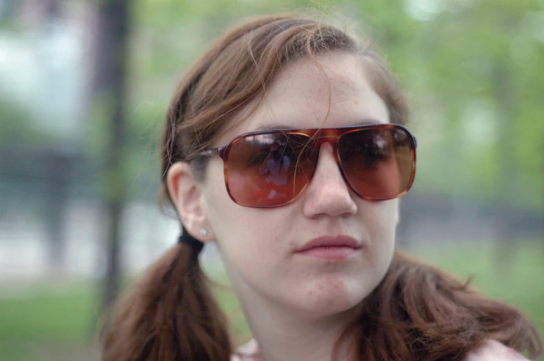 a woman with a pair of glasses staring forward