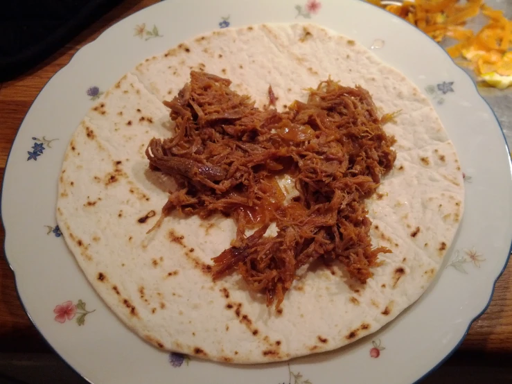 a tortilla sitting on top of a white plate