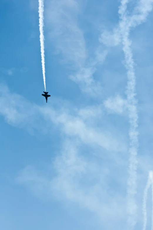 an airplane leaving a trail of smoke behind it