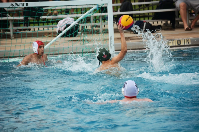 two men in water polo uniforms playing volley ball