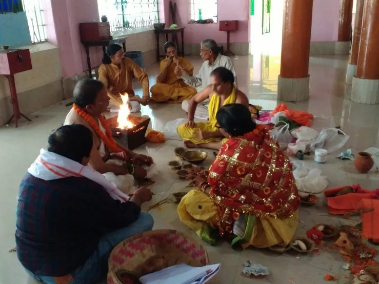 group of women in brightly colored clothing are sitting on the floor