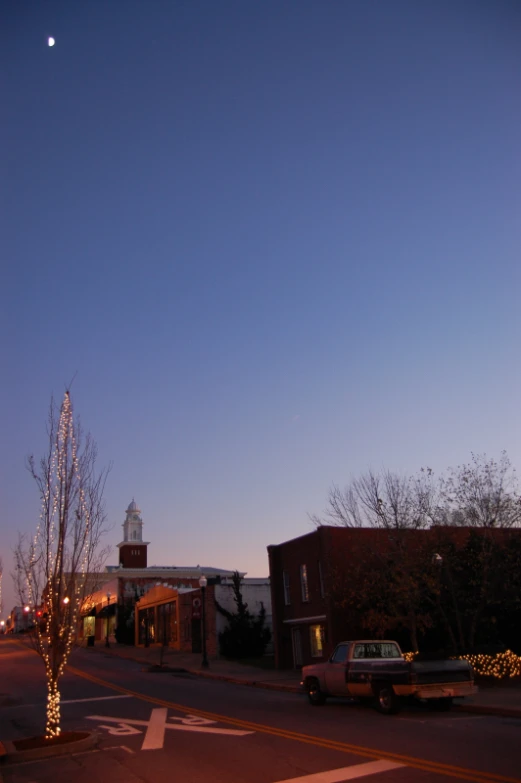 a night view with a full moon behind the buildings