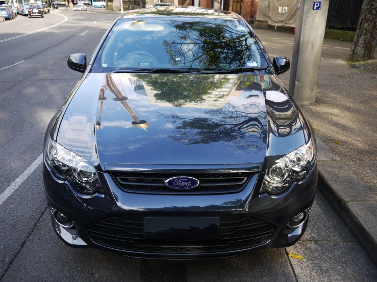 there is a very small car parked on the sidewalk