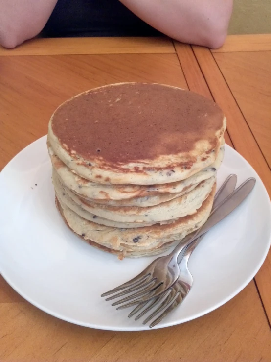 a white plate topped with pancakes and a fork