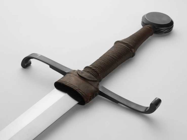 a large metal bladed sword with wooden handle