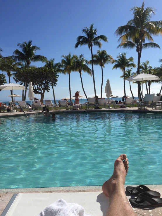 a man laying down next to a pool