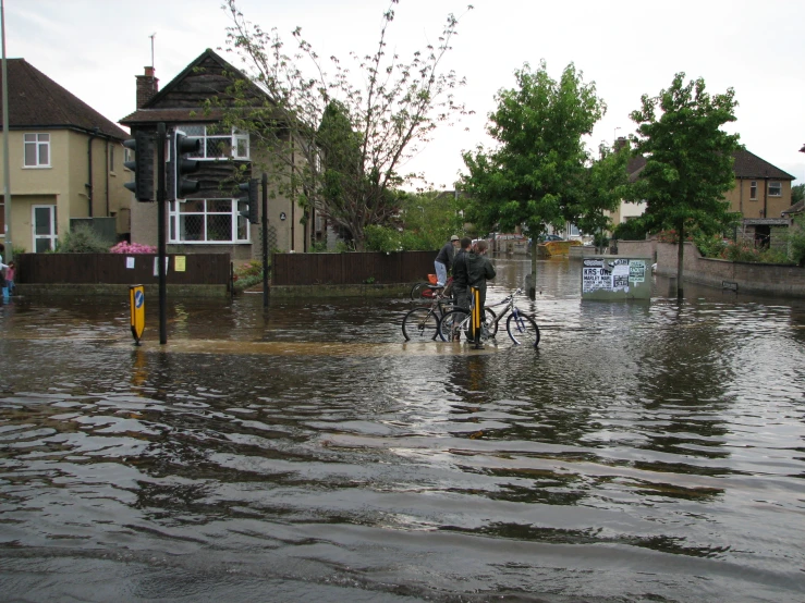 a bike is in the flooded street near houses